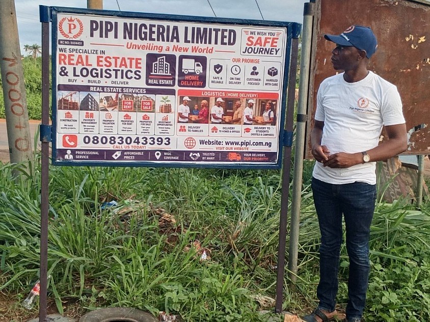 The Company MD, Mr. Ahmed, observing the Company's Iron Roadside Board at Bolorunduro Express Junction, just after Ilesa School Of Health Technology
